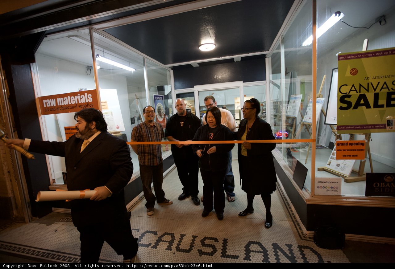 Group of adults posing in front of a store