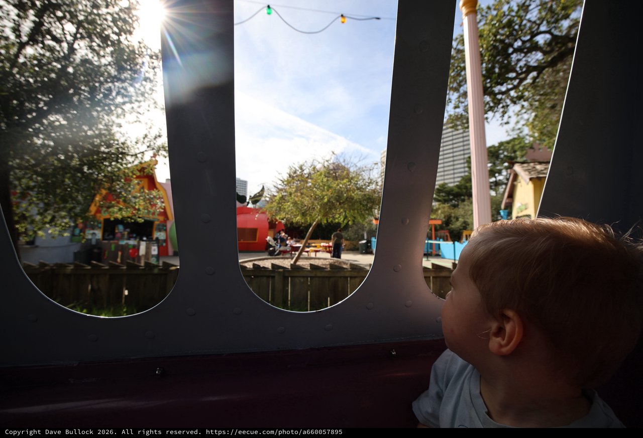 Child's Wonder: Peering Through Playground Windows