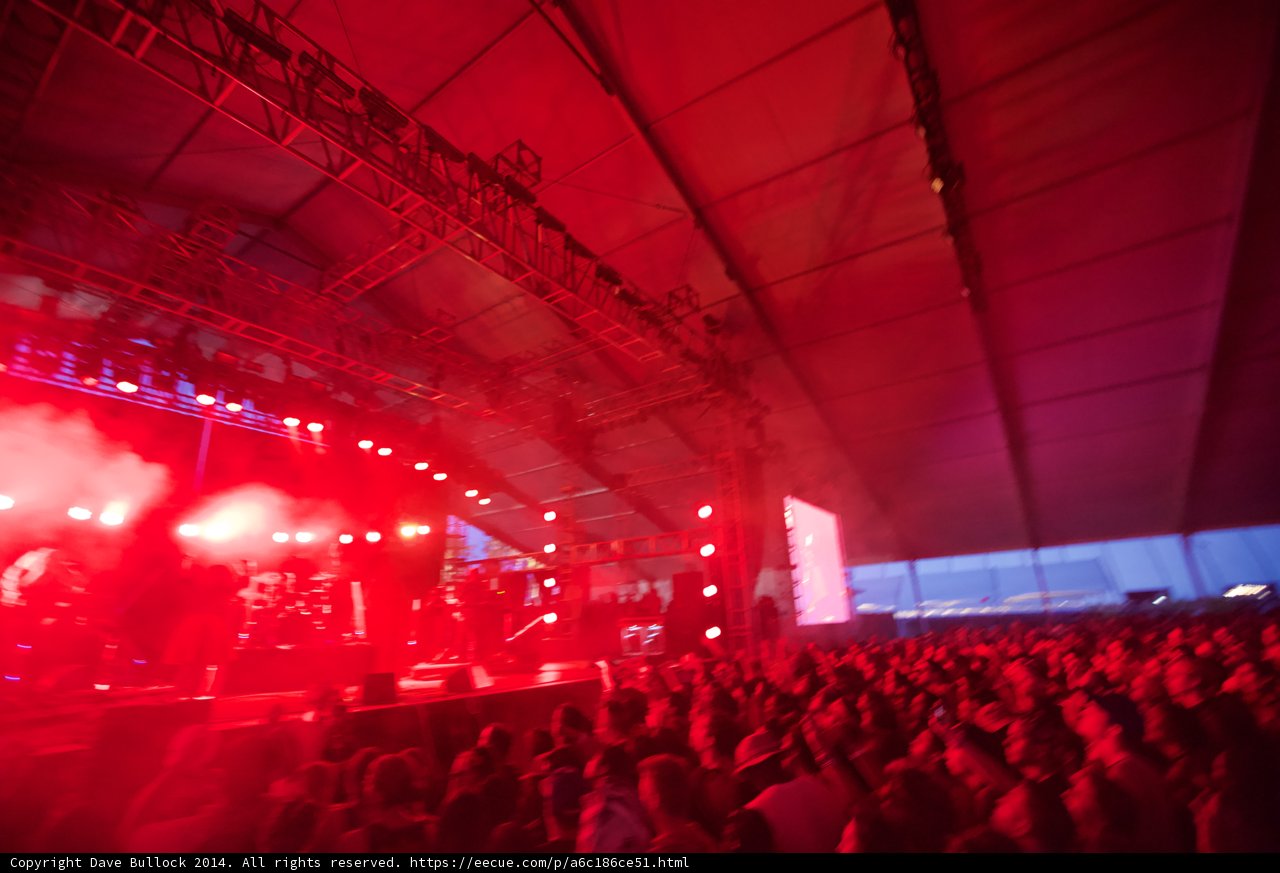 Red Spotlight on A Rock Concert Crowd