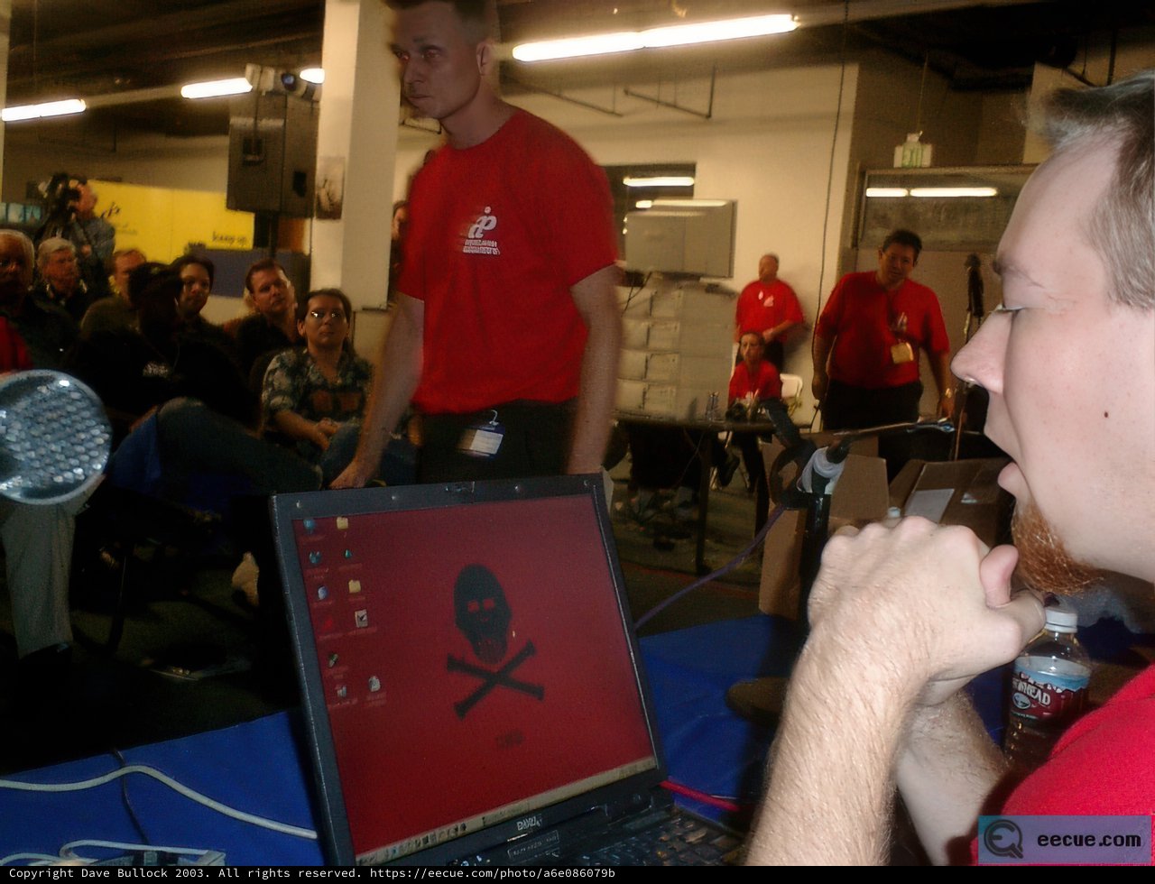 Man in Red Shirt Working on Laptop