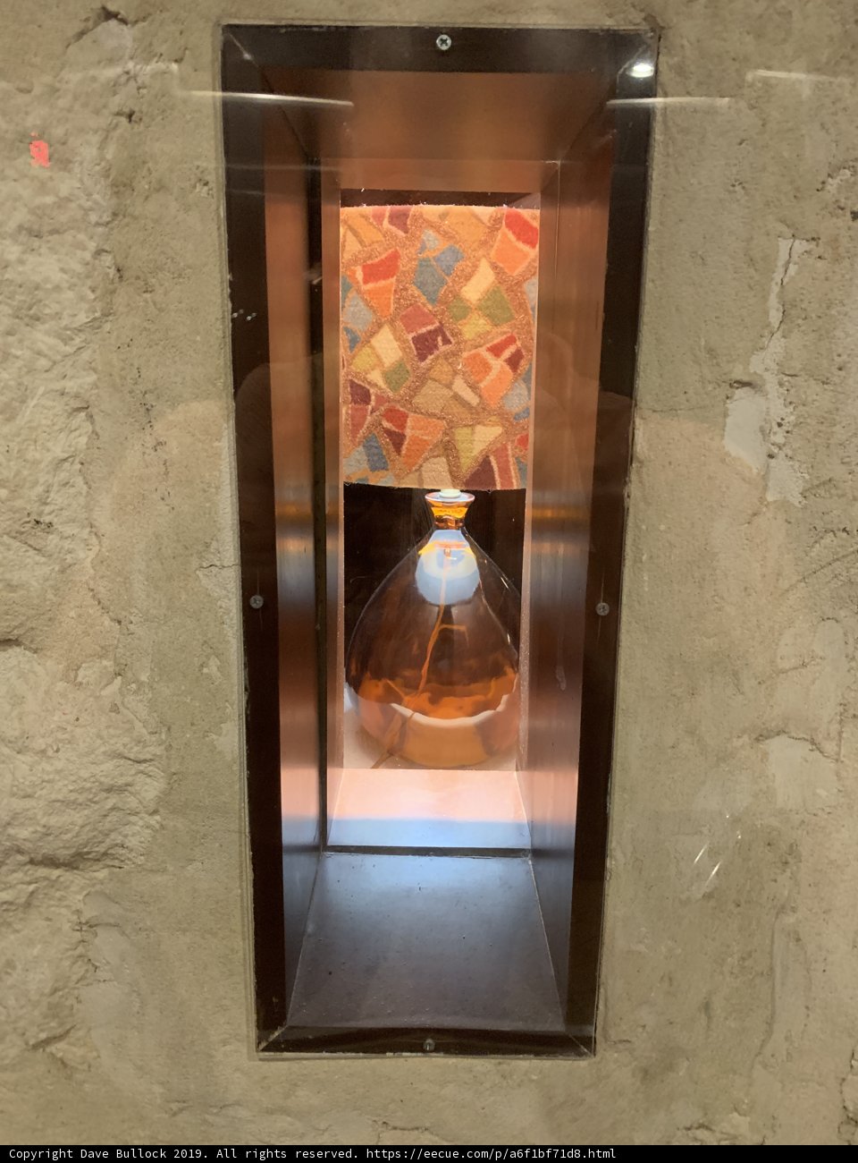 A Glass Bottle in a Metal Box