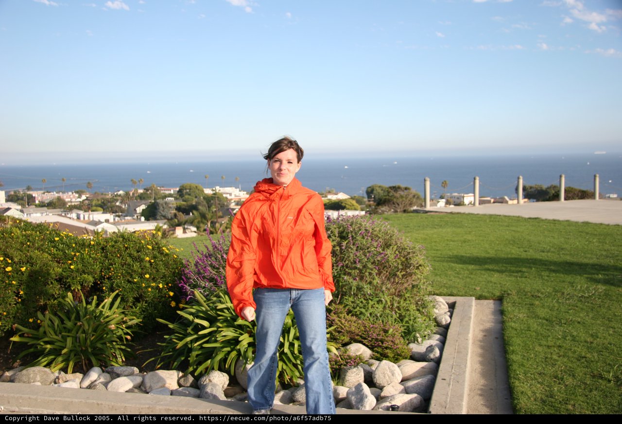 Woman in Orange Jacket Overlooking Coastal California Town
