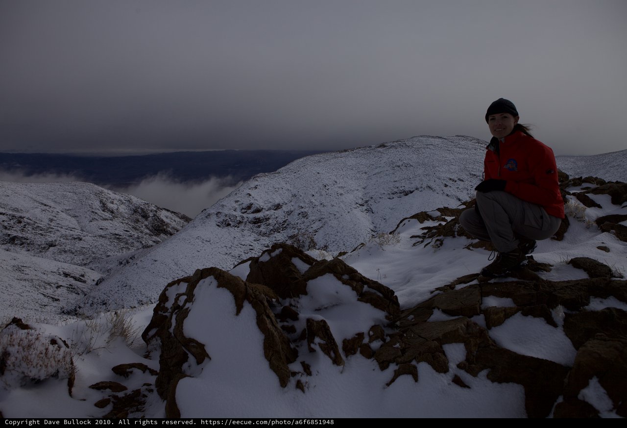 Winter Summit Rest on Snow-Covered Mountain Ridge
