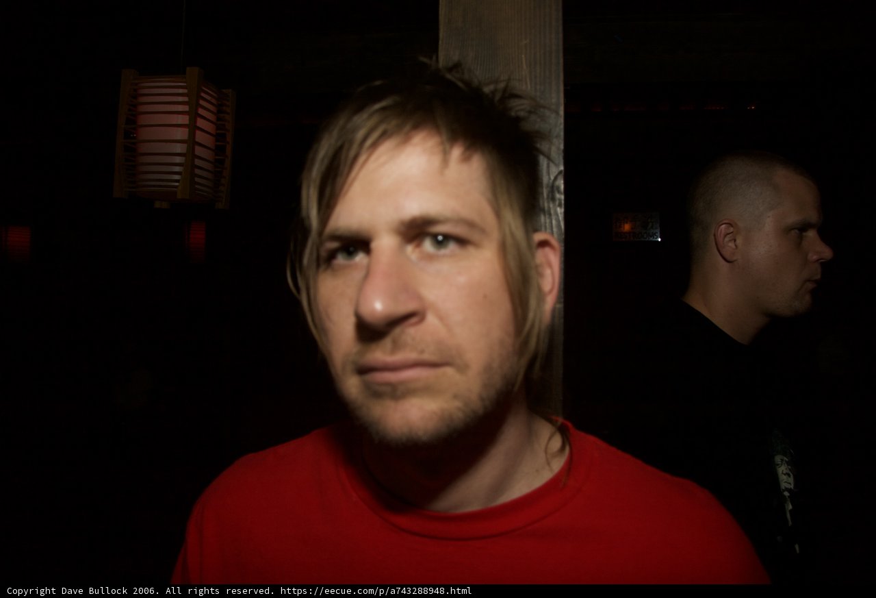 Red Shirt and a Man in the Background