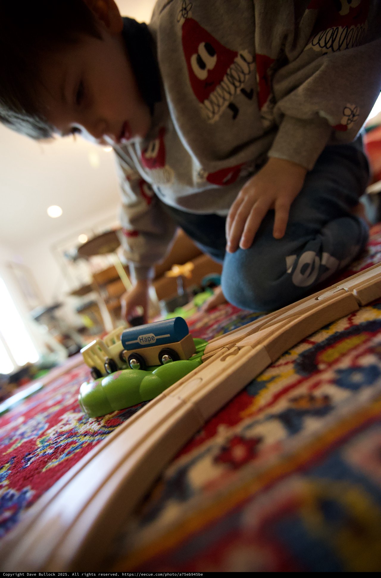 Child Playing with Wooden Train Set on Christmas Day