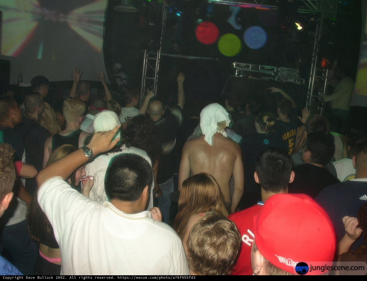 Nightclub Crowd with Spotlight on a Man in White