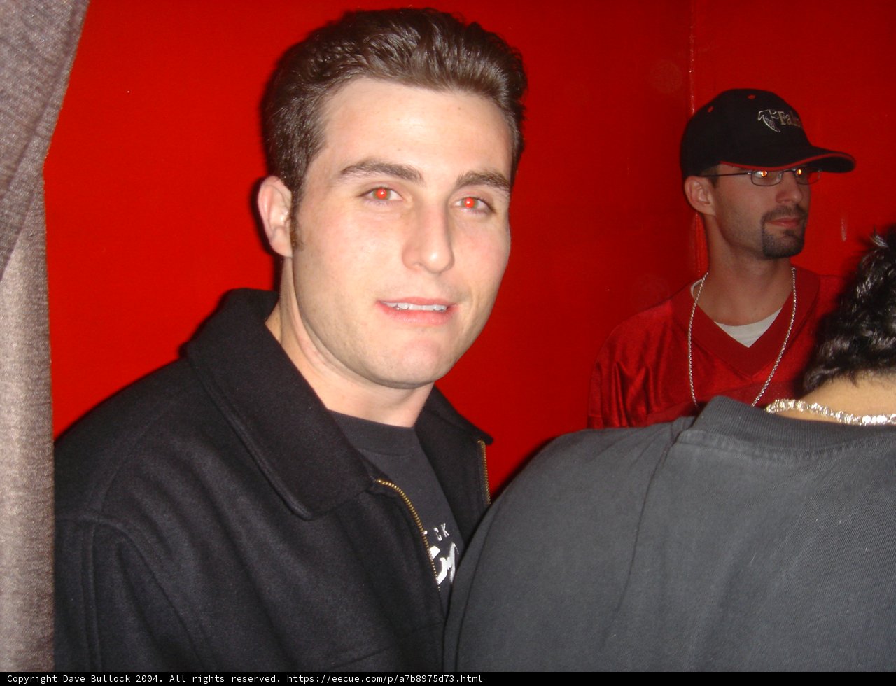 Stylish Man in Black Jacket and Baseball Cap