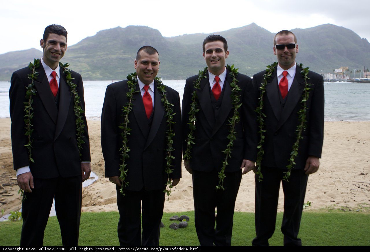 Four Men in Formal Wear Pose on Hawaii's Cloudy Shore