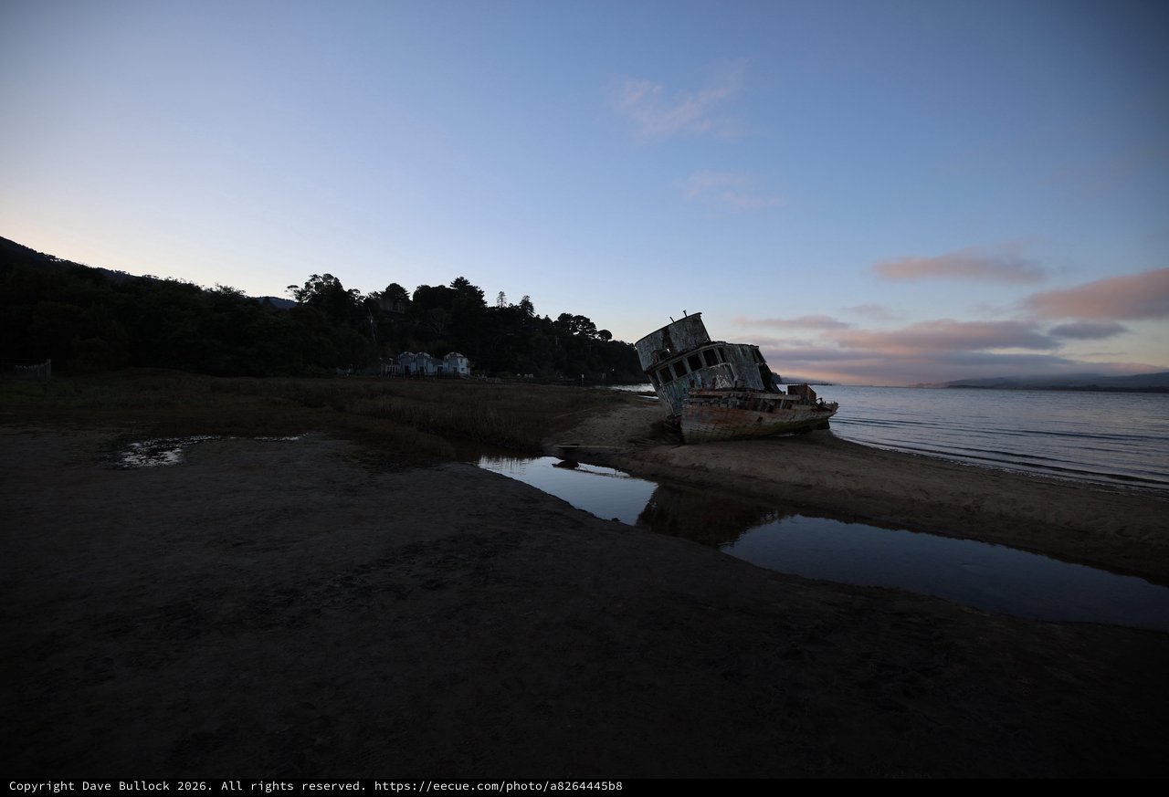 Abandoned Shipwreck at Dusk on Tidal Beach