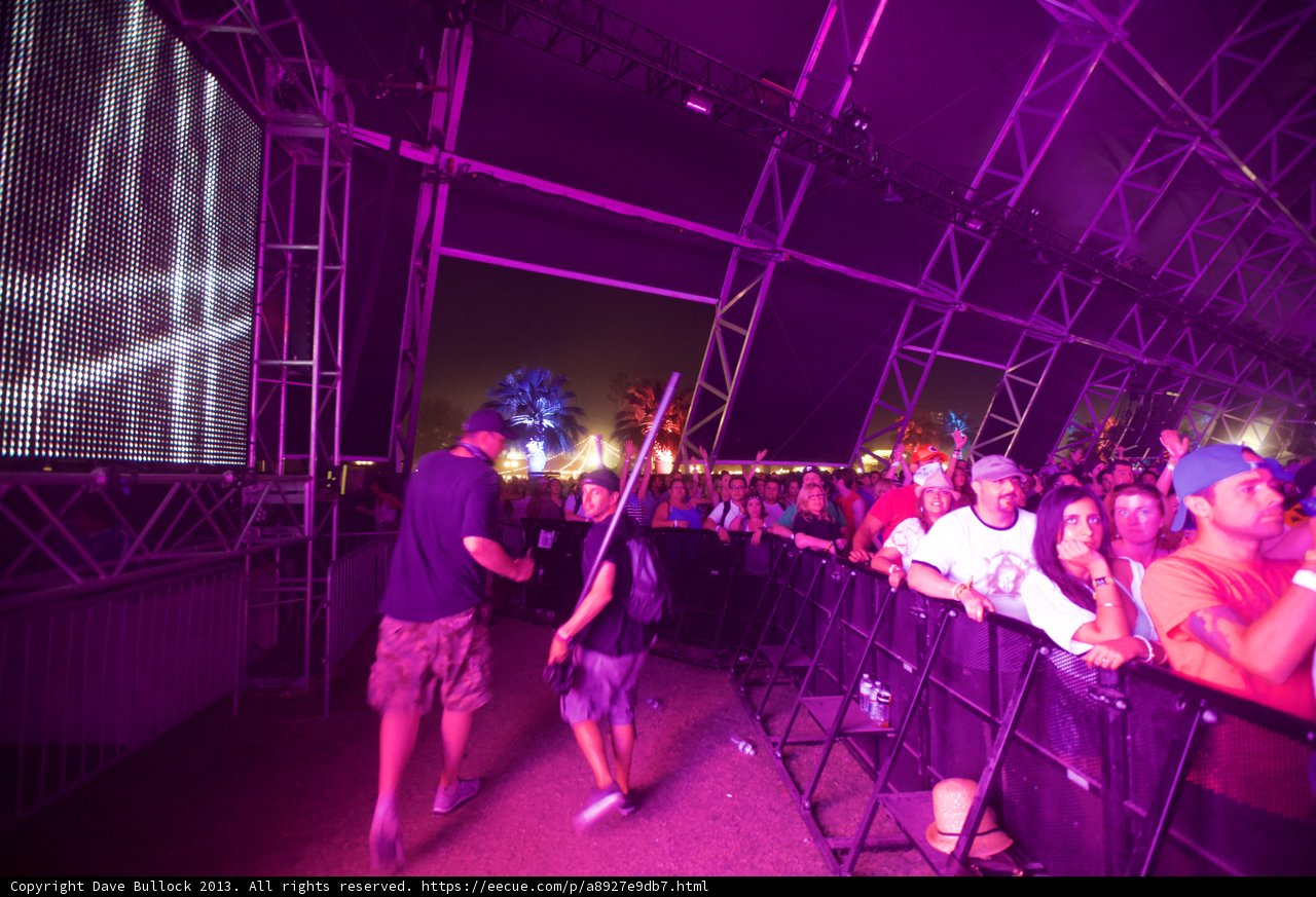 Partygoers Enjoying a Concert at Coachella with Large Screen