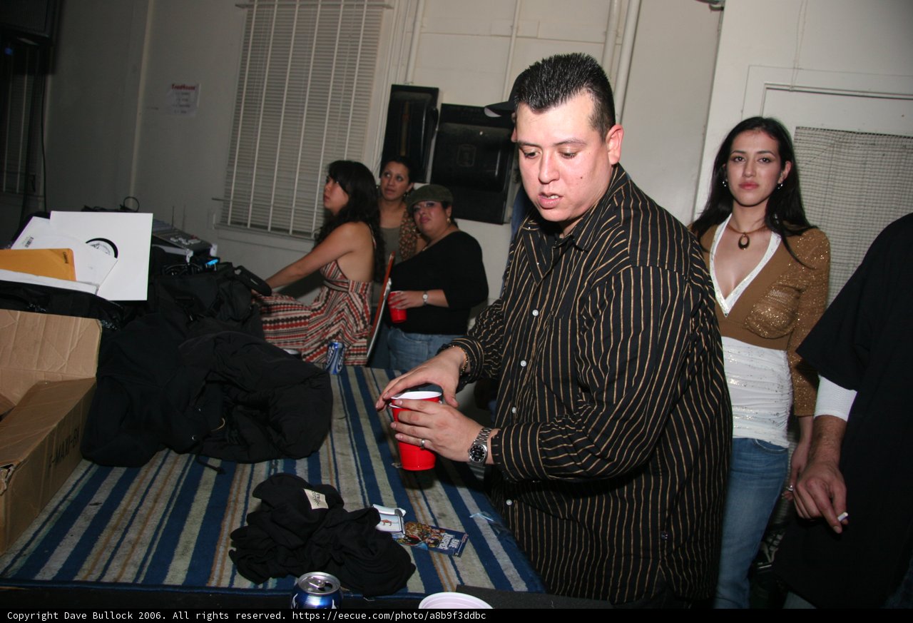 Black Shirted Man Sitting on Couch with Friends