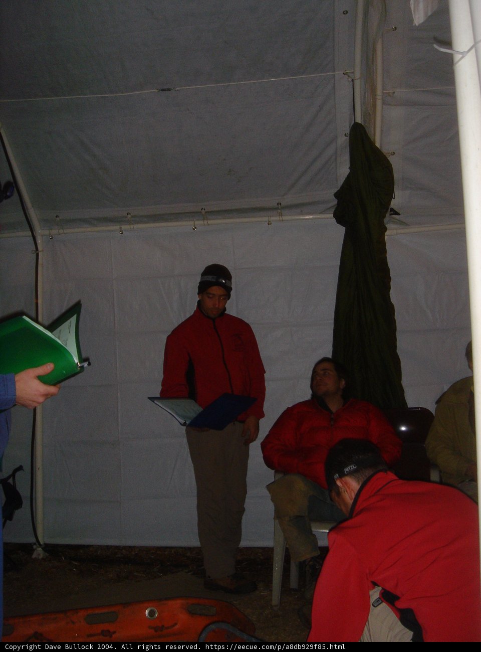 Red-Jacketed Man Takes Shelter Among the Buildings