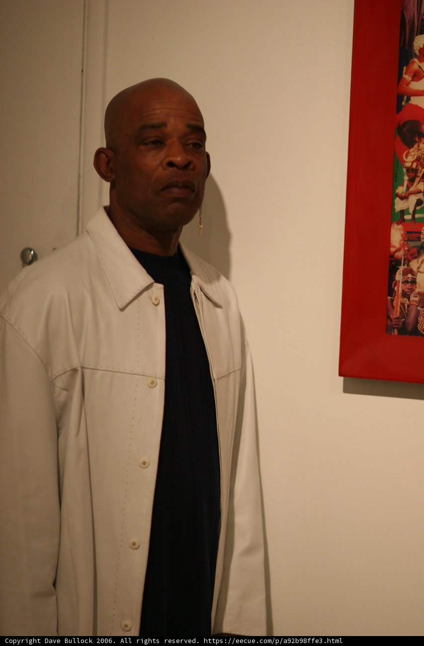 Man Admiring a Painting in a Stylish Overcoat