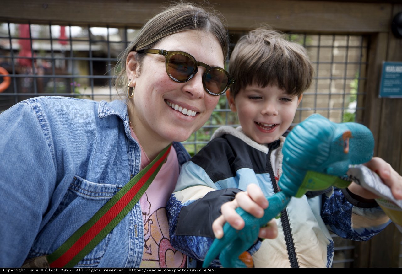 Joyful Mother and Son with Toy Dinosaurs