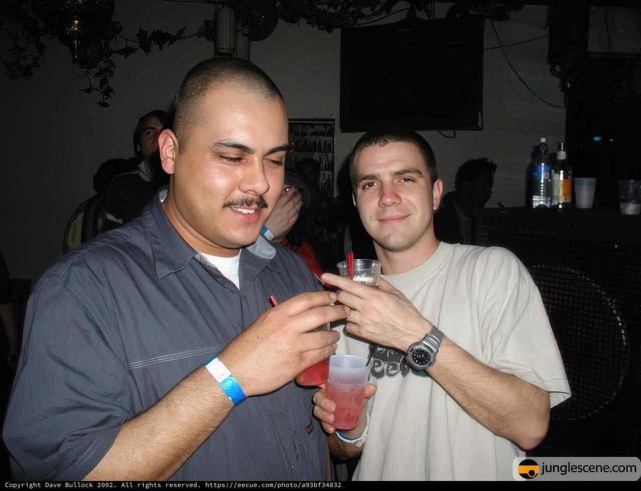 Two Men Enjoying Drinks at Nightclub