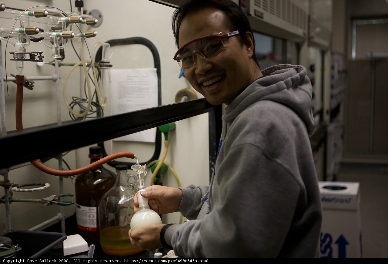 Man in Glasses Holding a Glass Bottle in UCLA Nanotech Lab
