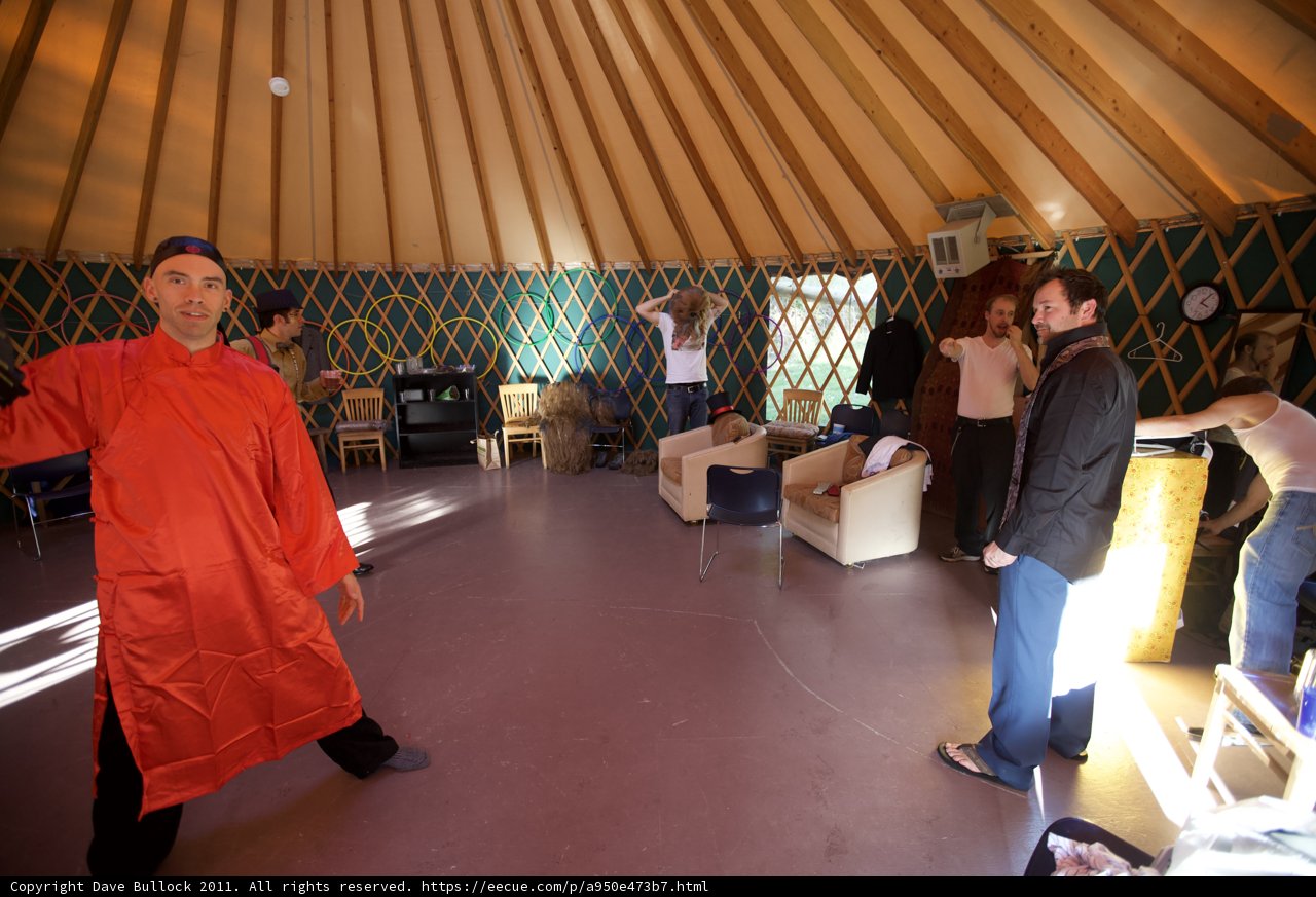 Man in Red Robe Standing in Yurt