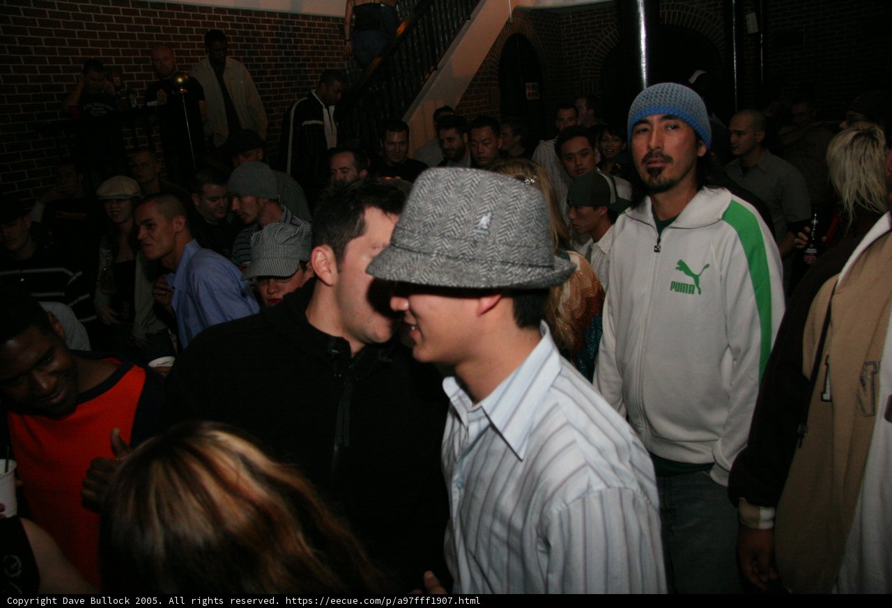 Man in a Stylish Beanie Hat in a Busy Bar
