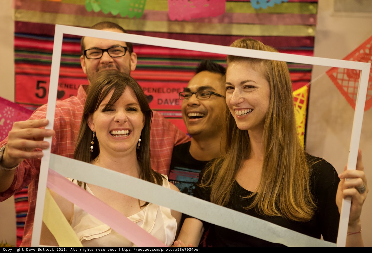 Friends Laugh Through a Giant Photo Frame