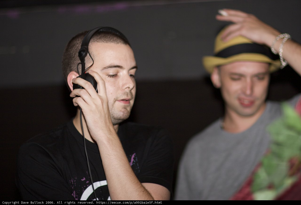 Two Men With Hats and Phones