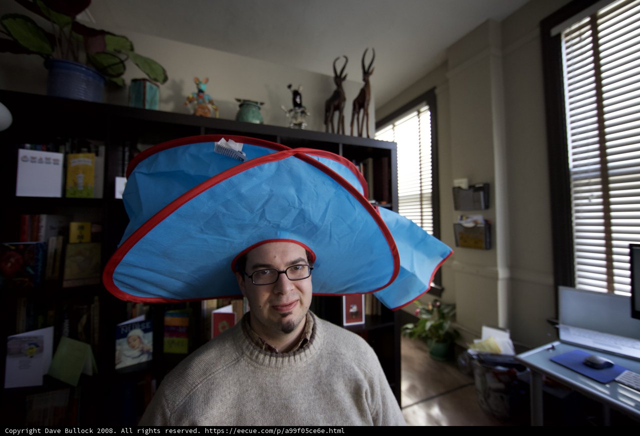 Hat-wearing Man Enjoys Indoors