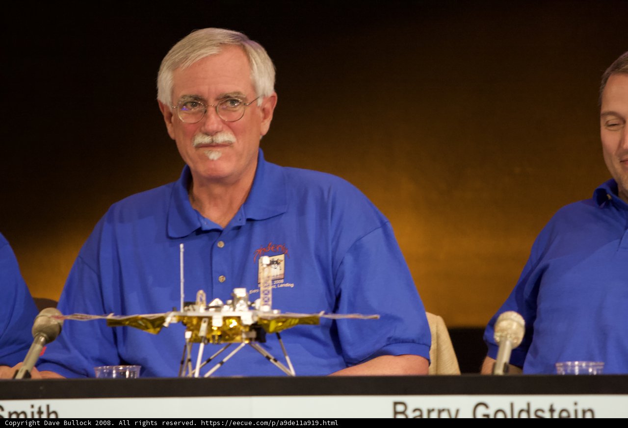 Press Conference with Three Men in Blue Shirts