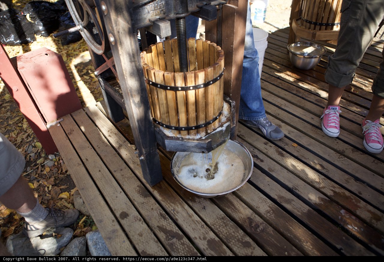 Pouring Liquid into a Wooden Bucket