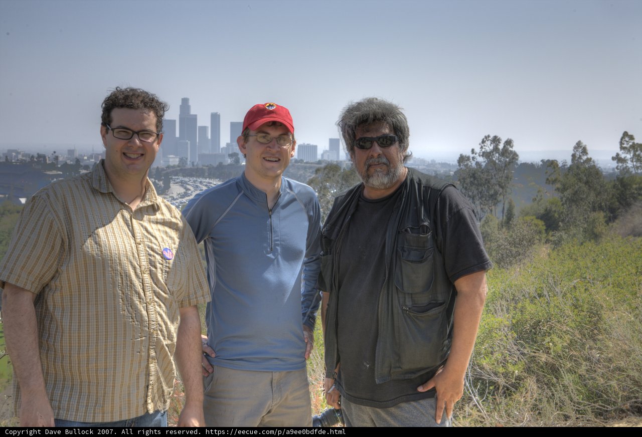 Three Men Enjoying a Sunny Day Outdoors