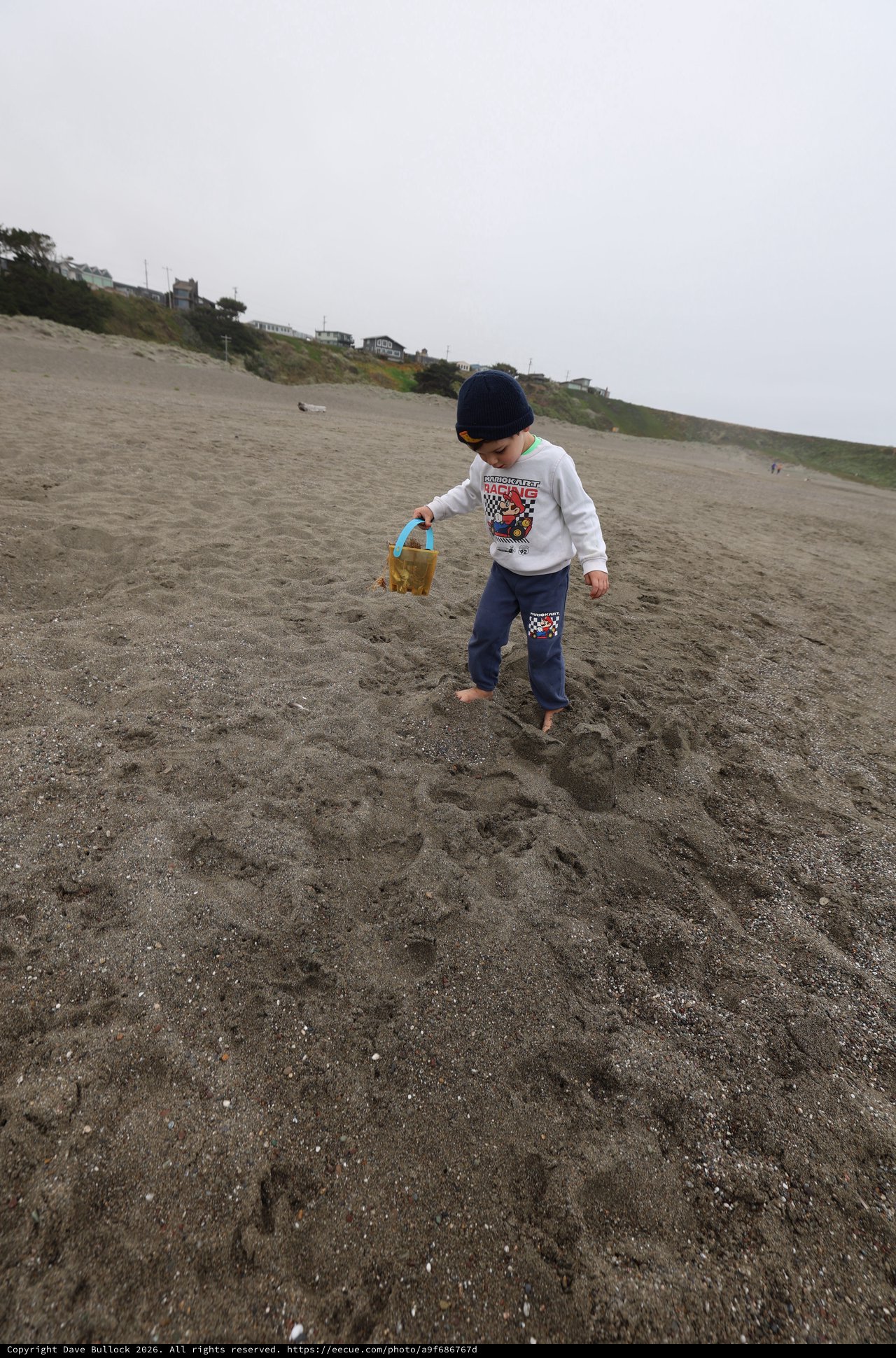 Young Explorer Walking Barefoot on Foggy Beach