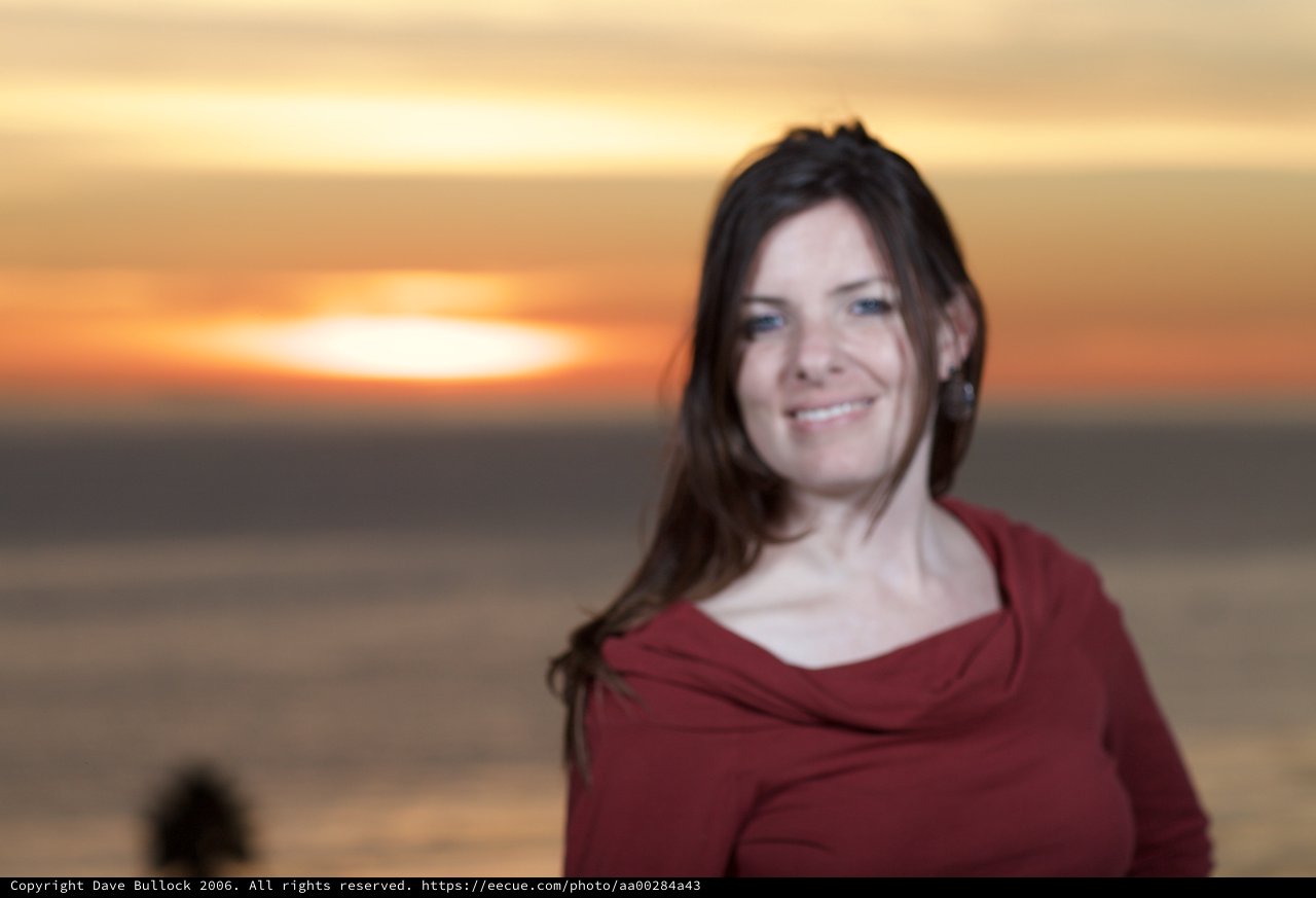 Smiling Woman Glowing in Seaside Sunset Light