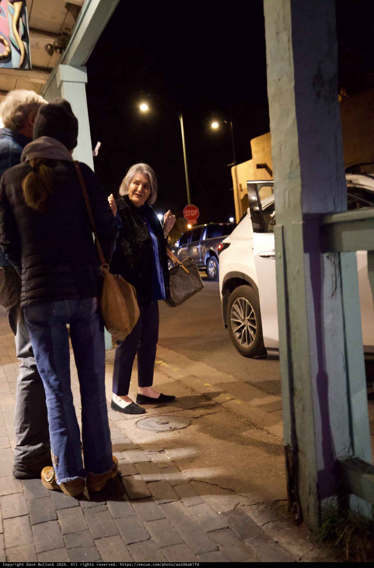 Evening Street Scene with Woman on Urban Sidewalk