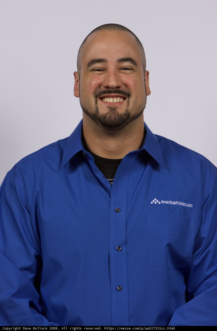 Blue-shirted man with a big smile