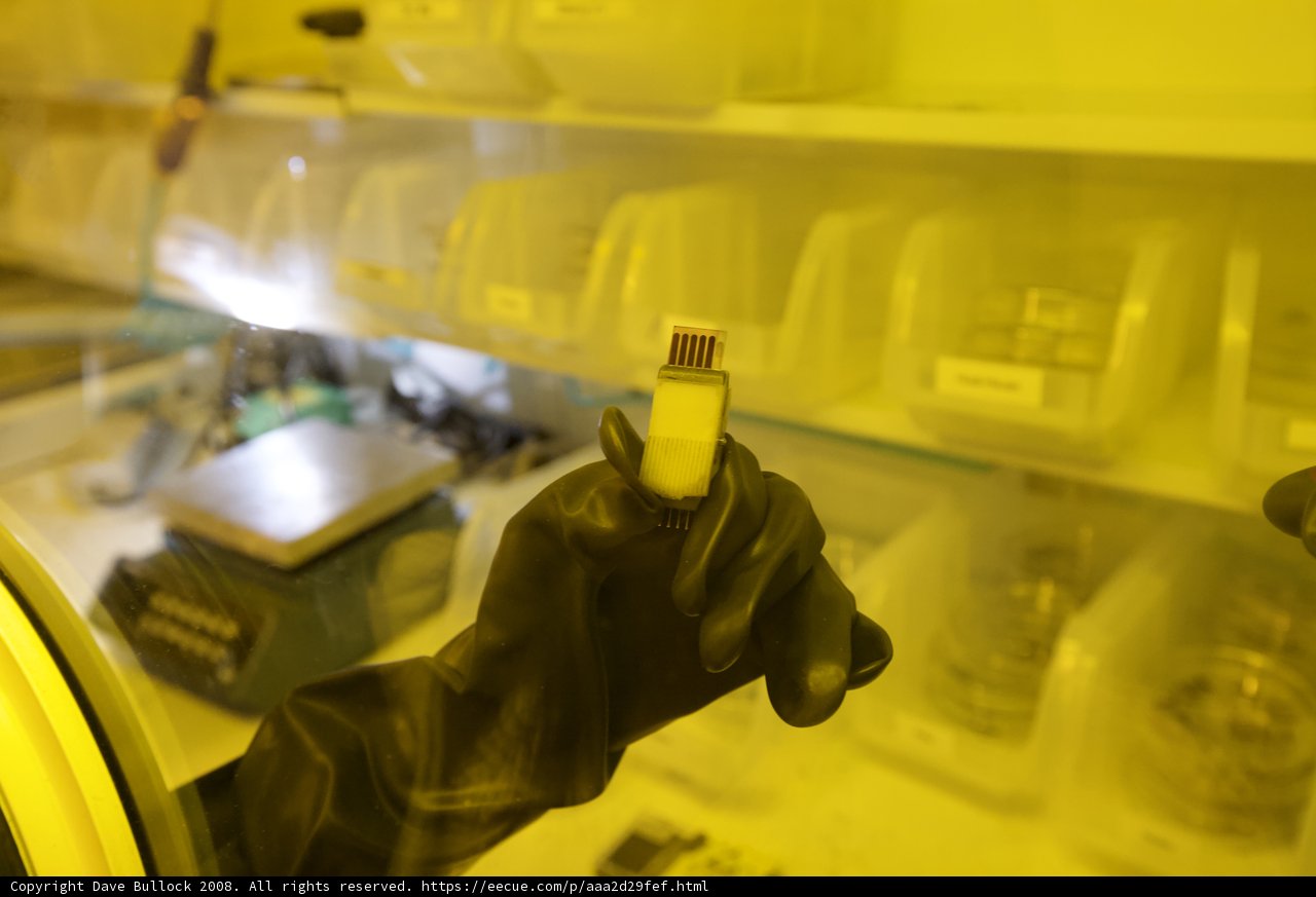 Gloved Hand Holds Small Object in UCLA Quantum Nano Lab