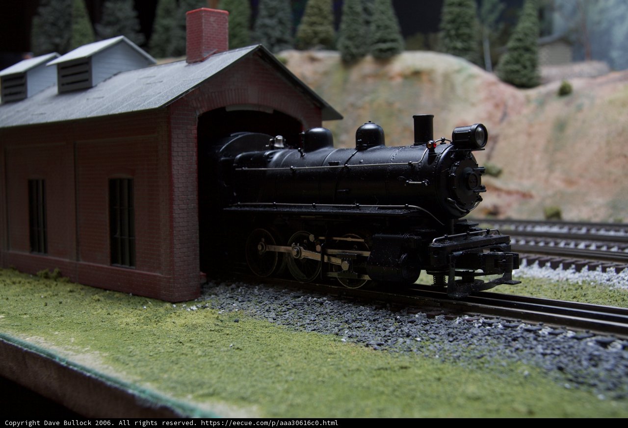 Toy Train Engine Parks in Front of Museum Building