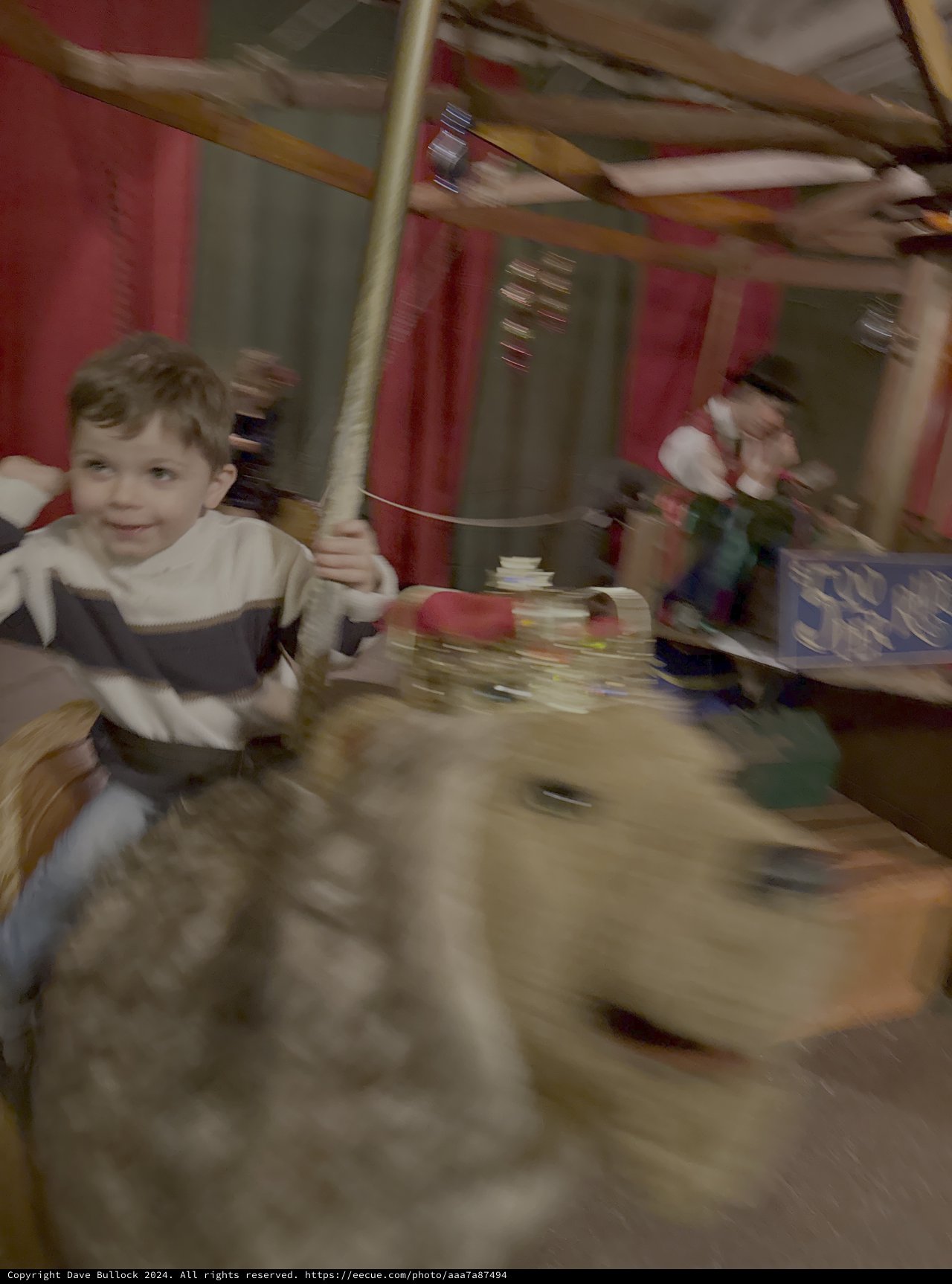 Child Enjoying Carnival Carousel Ride Experience