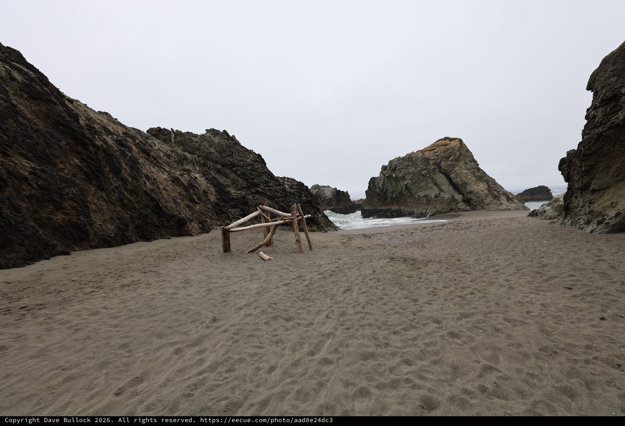 Secluded Coastal Cove with Driftwood Structure