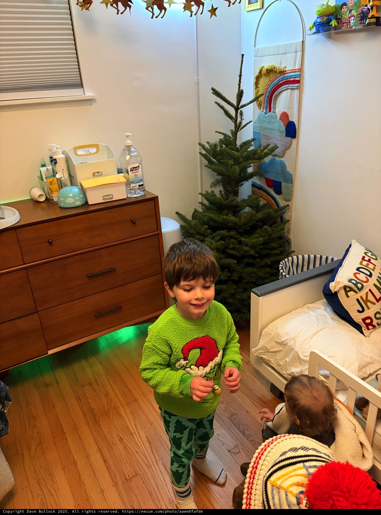 Siblings Decorating Christmas Tree in Cozy Bedroom