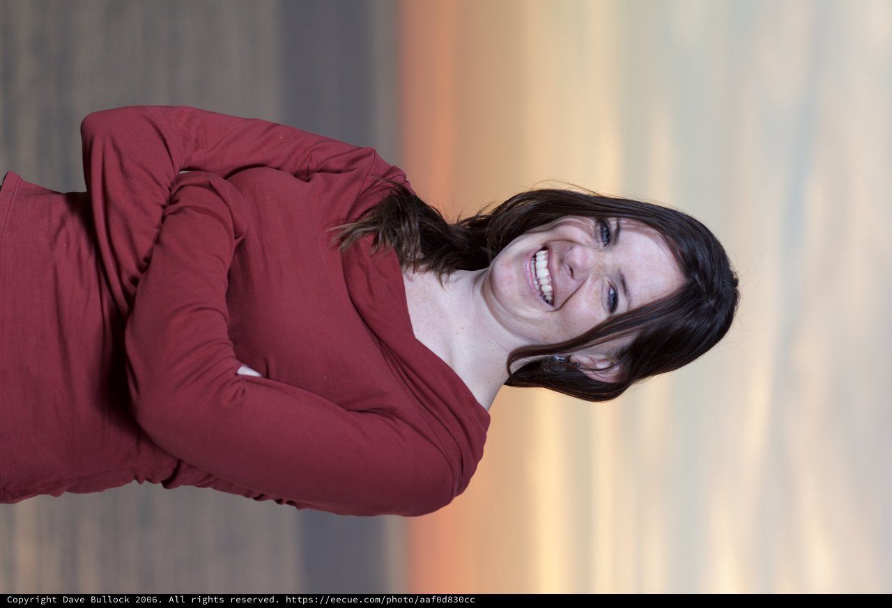 Joyful Woman Laughing at Sunset by the Sea