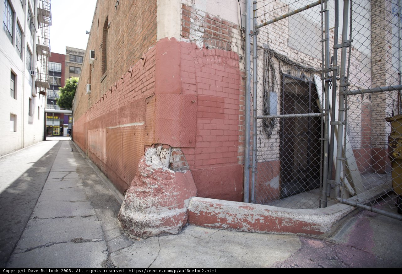 The Brick Building and Chain Link Fence in the City