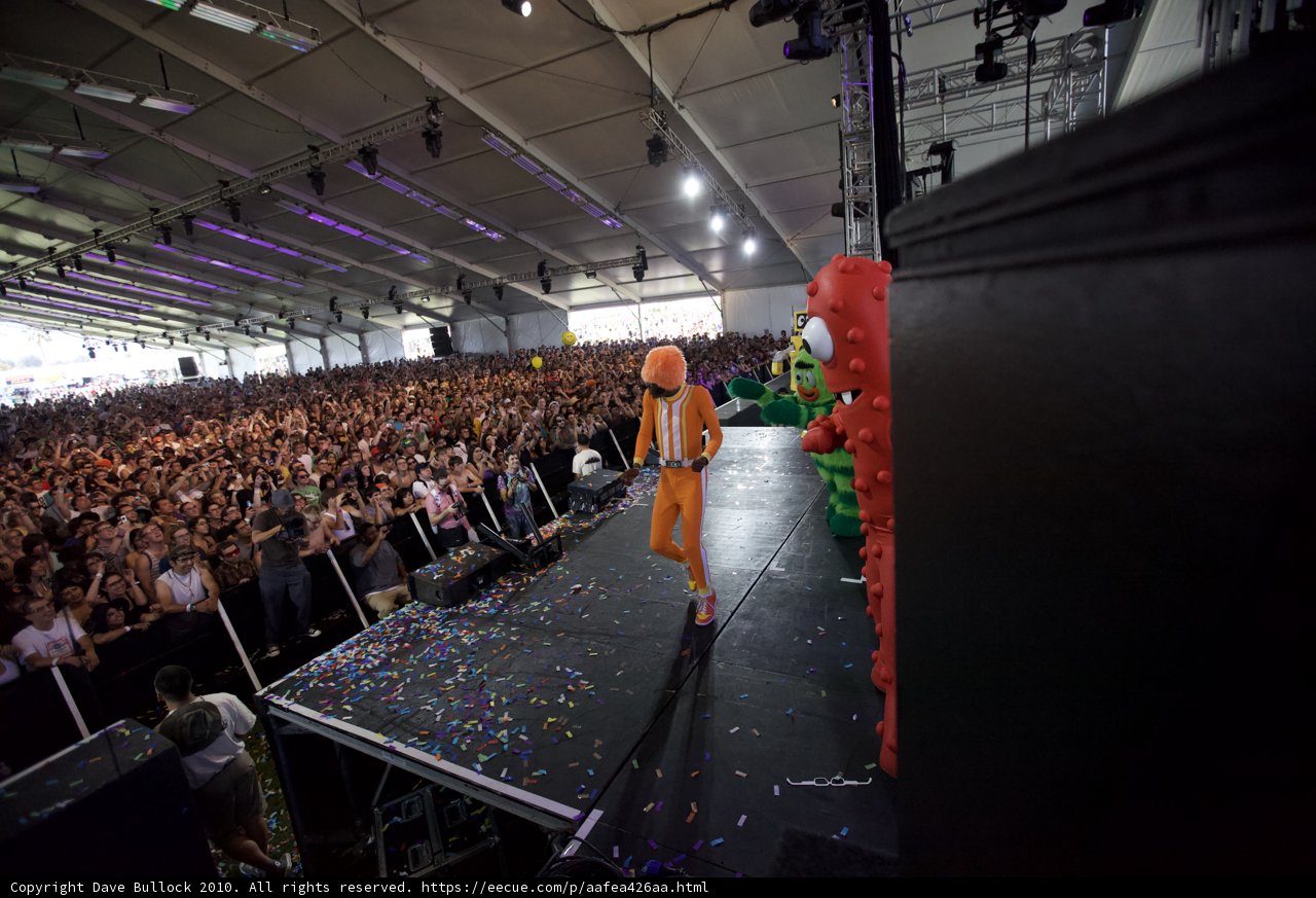 Orange-clad performer celebrates with crowd