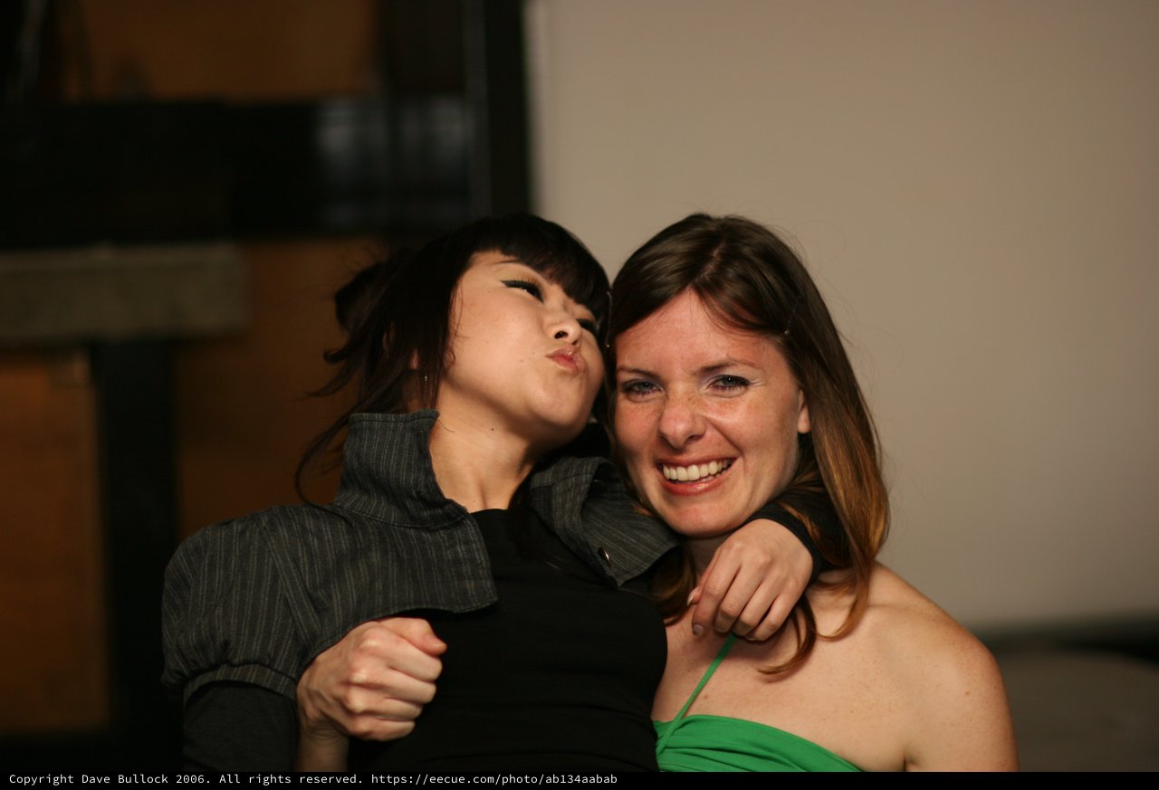Two Friends Laugh and Pose at a Party