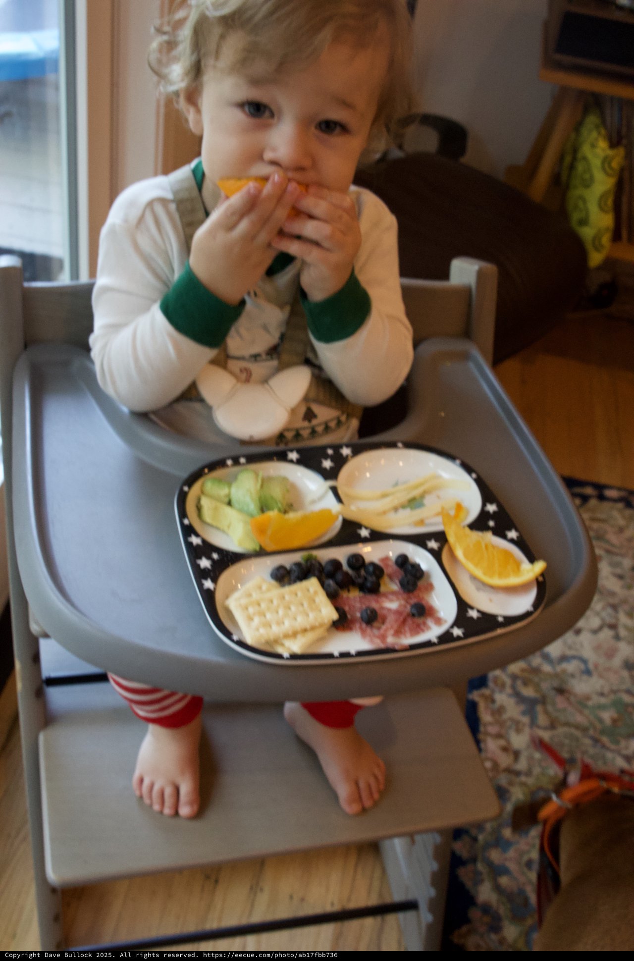 Toddler Enjoying Healthy Snack Time in High Chair