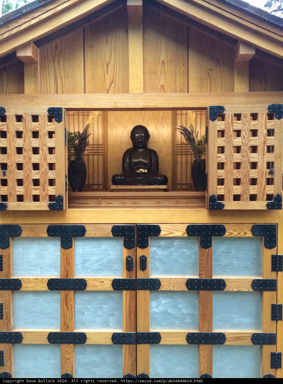 Buddha Statue Sitting on Wooden Door