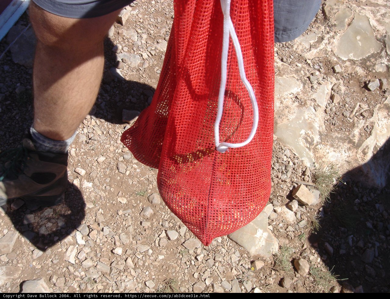 Red Mesh Bag on a Dirt Road