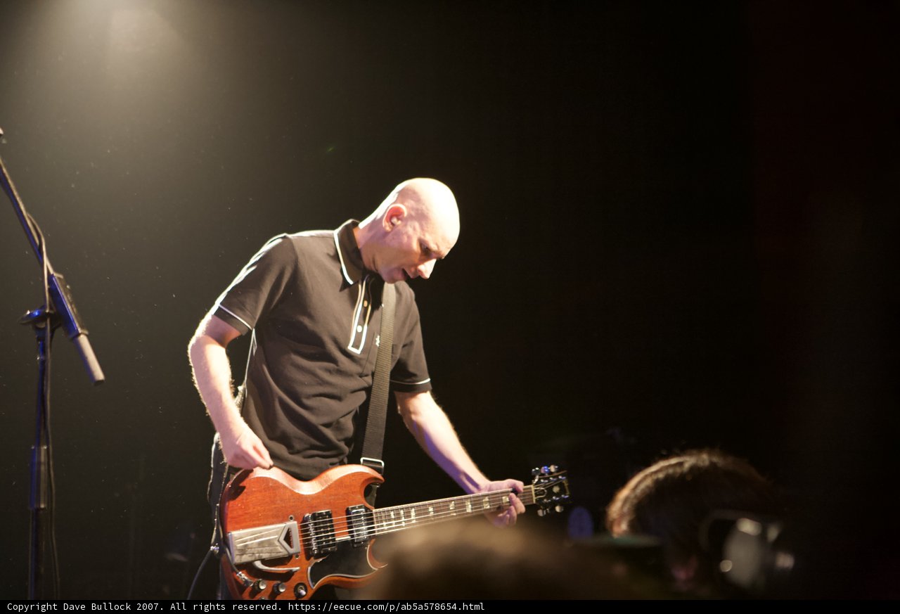 Bald Man Rocks Out on Guitar