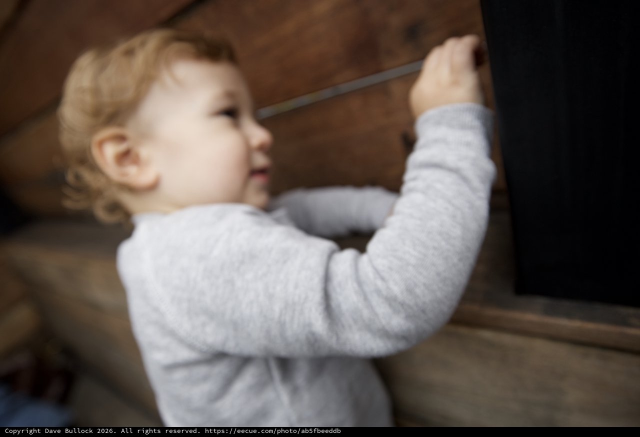 Toddler Reaching Up Indoor Wooden Staircase