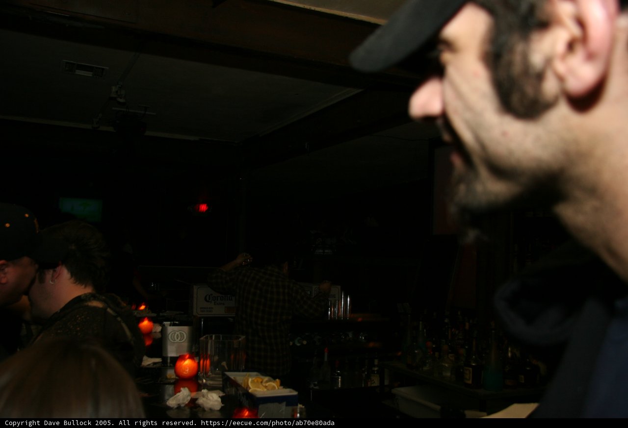 Man in Baseball Cap at the Bar