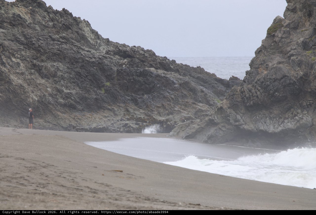 Solitary Figure at Misty Rocky Cove Beach