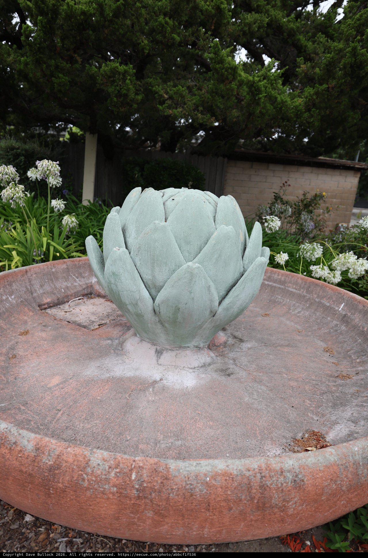 Artichoke Fountain Sculpture in Serene Garden Setting