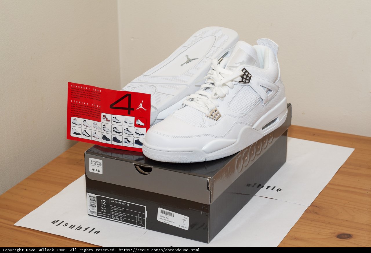 White Sneakers Perched on Cardboard Box